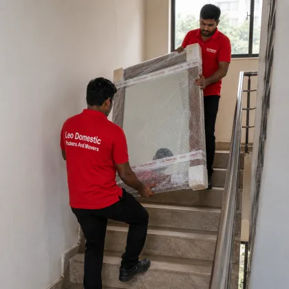 Leo Domestic Packers And Movers - Carrying a Wrapped Mirror